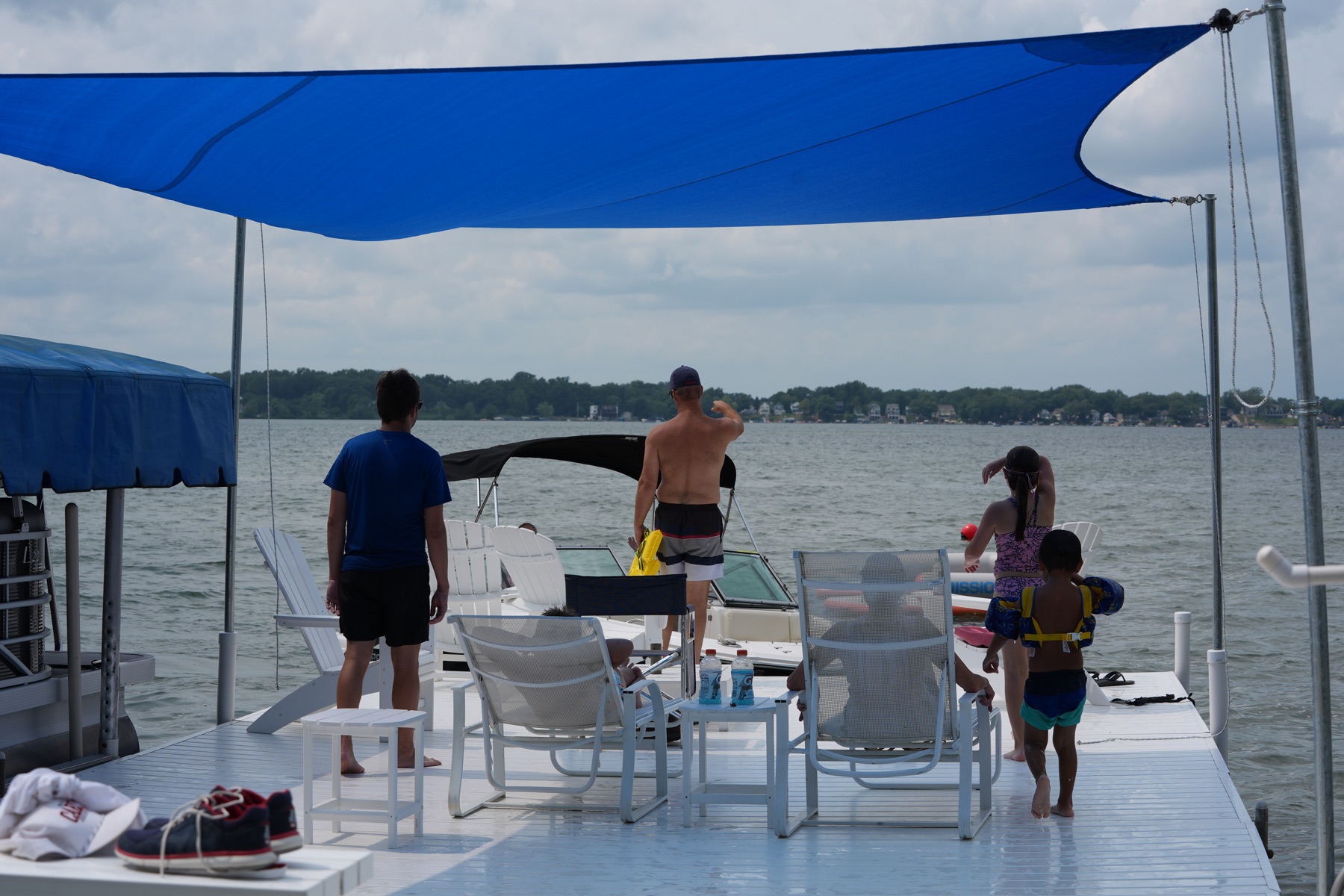 Family moving around the dock beneath an open DockShade